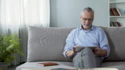 Employee sitting on couch at home working