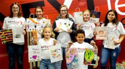 Next Level company kids show off the Halloween Treat bags they created for HOPE Week 2019