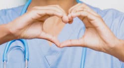 Nurse makes heart symbol with hands