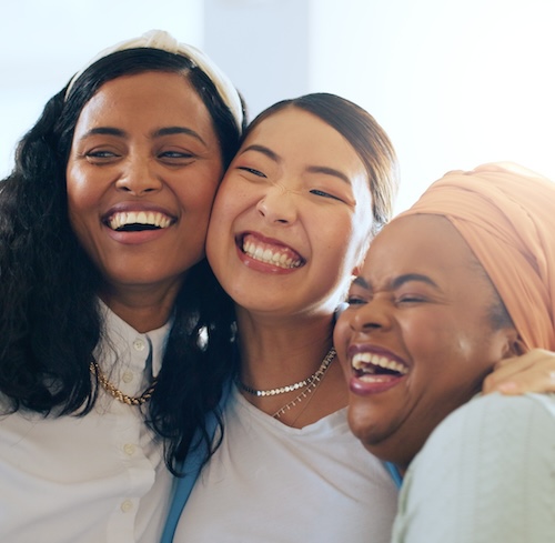 Three women hug
