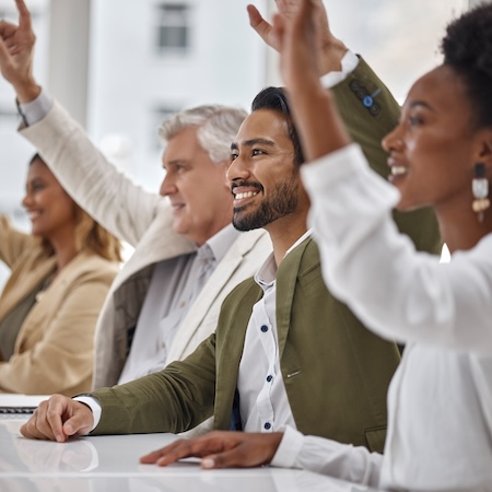 Colleagues raise hands