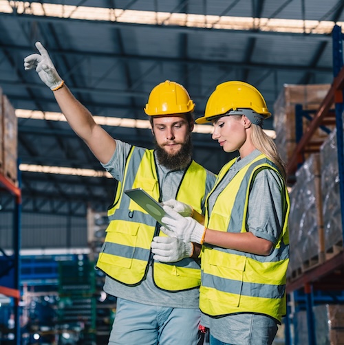 Warehouse worker pointing to something up high