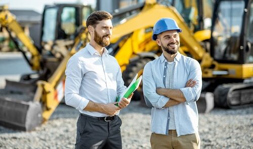 Construction Salespeople on site watching something out of scene