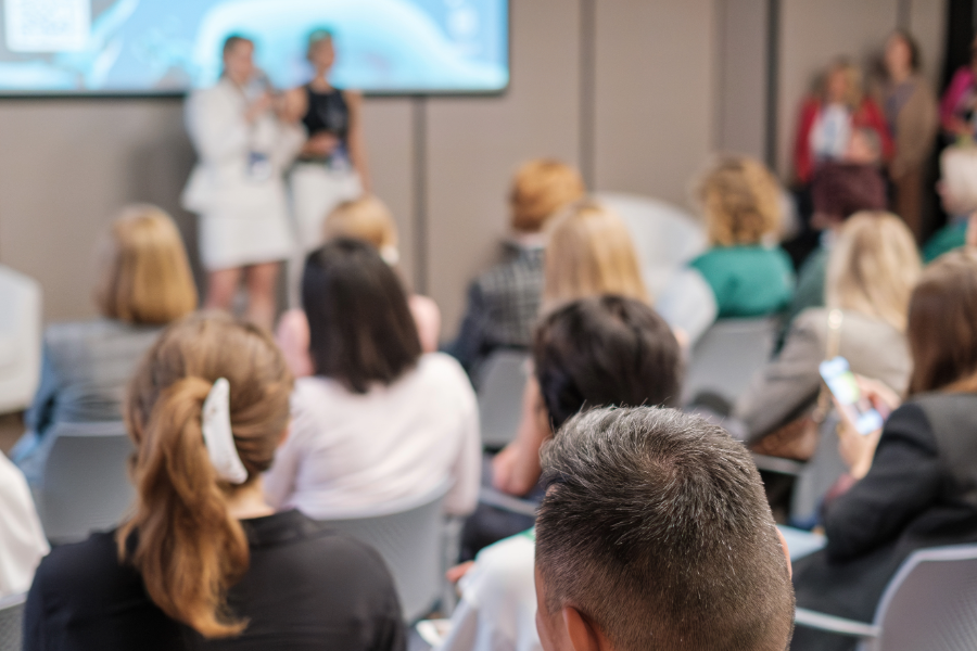 People in room listening to a speaker present