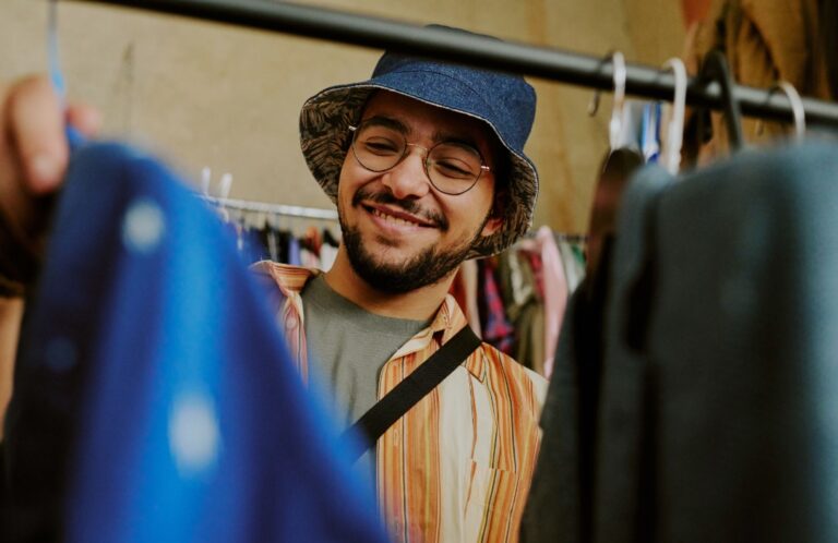 Person shopping and flopping through clothing options